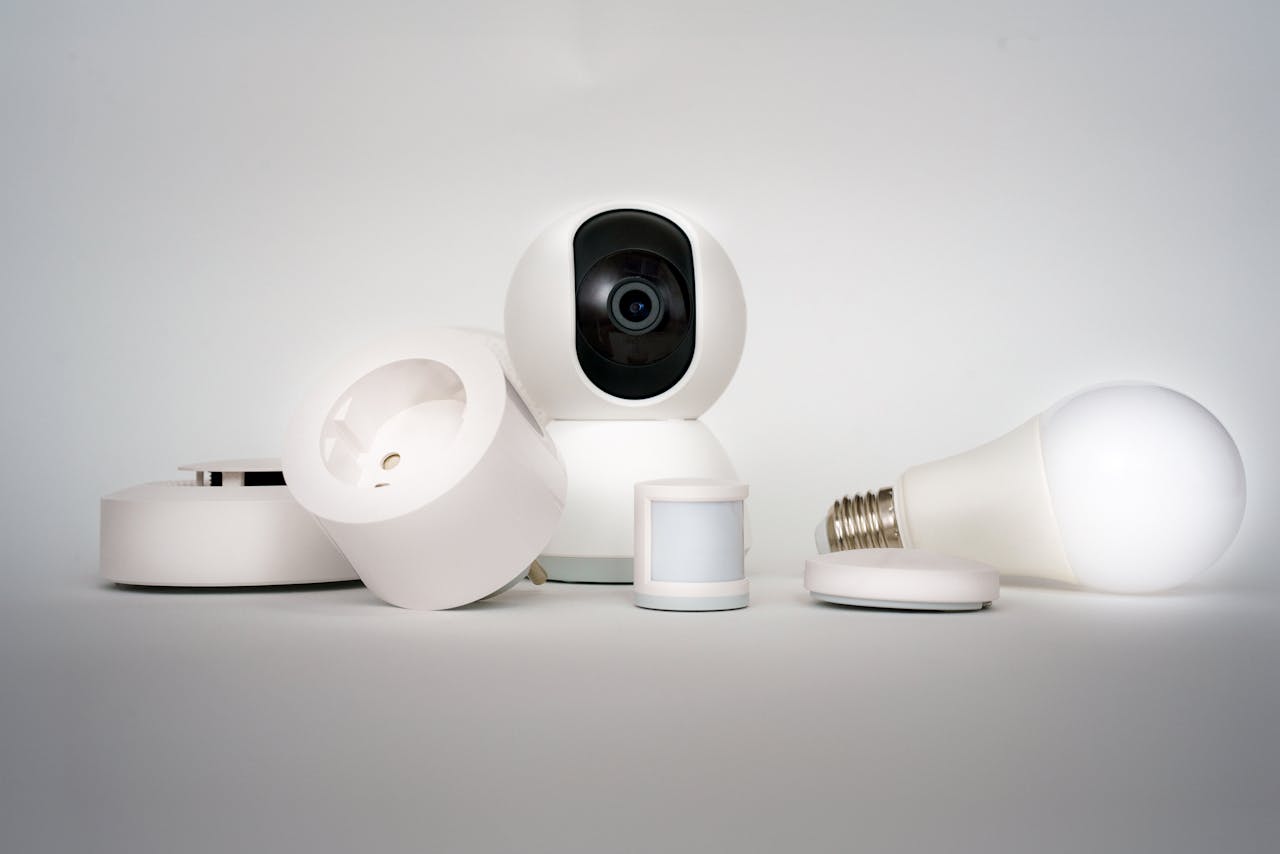 A range of smart home devices including camera and lightbulb in a minimalist setup.